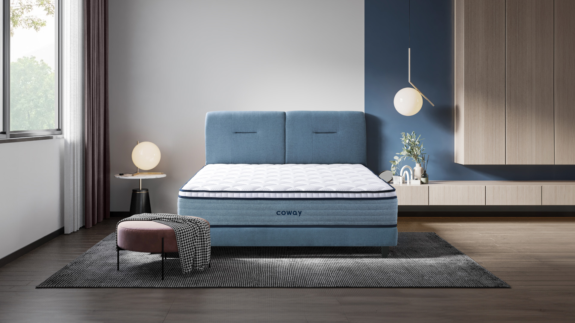coway-prime-lite-series-mattress-at-the-center-of-the-room-with-a-rug-underneath-and-a-low-chair-with-a-rug-draped-across